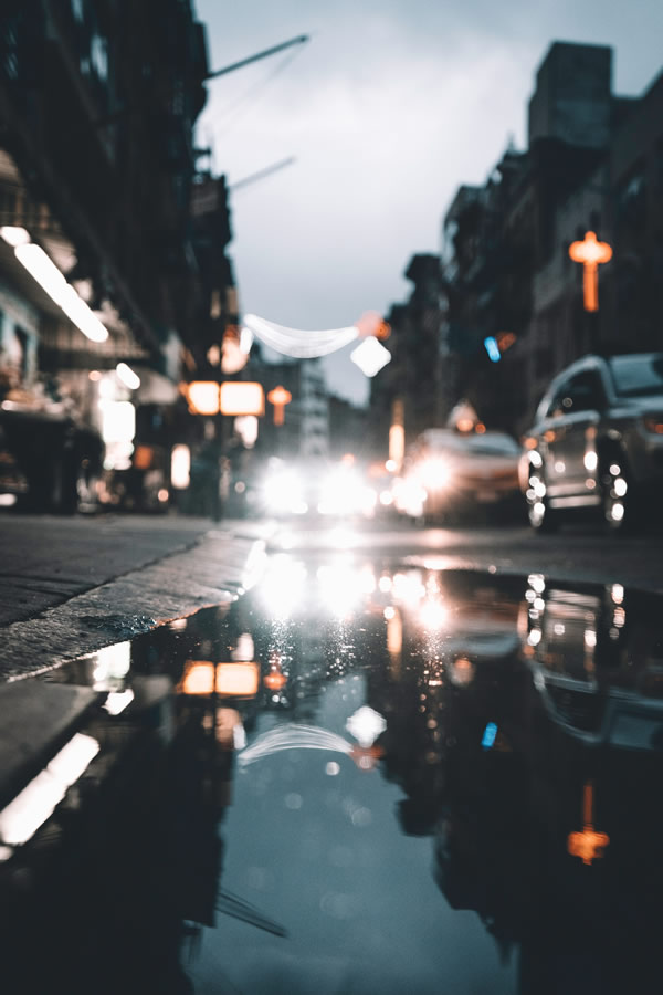 City lights reflected on a rain-covered street